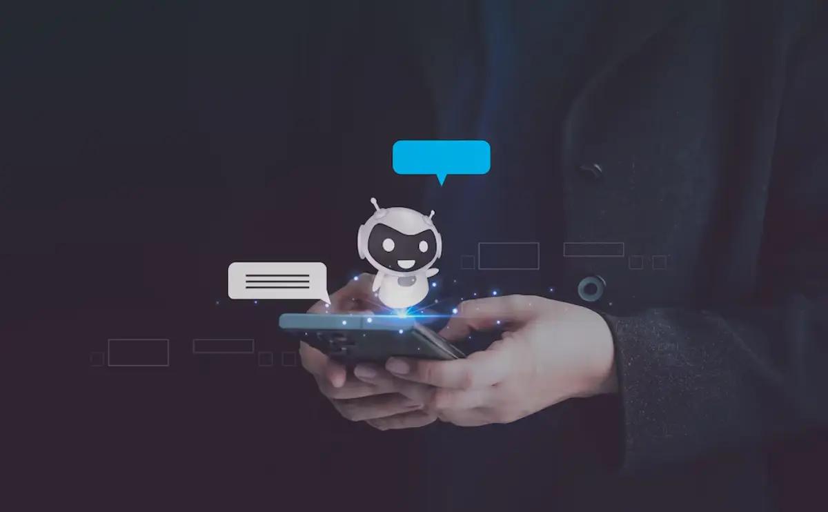 A person holds a smartphone displaying a digital chatbot with speech bubbles, symbolizing AI communication and technology.