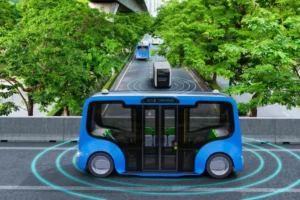 A futuristic blue self-driving bus on a tree-lined road, marked by digital signals, showcasing advanced transportation technology.