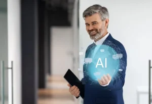 A businessman in a suit holds a tablet and gestures towards a holographic display with AI highlighted, surrounded by digital elements.